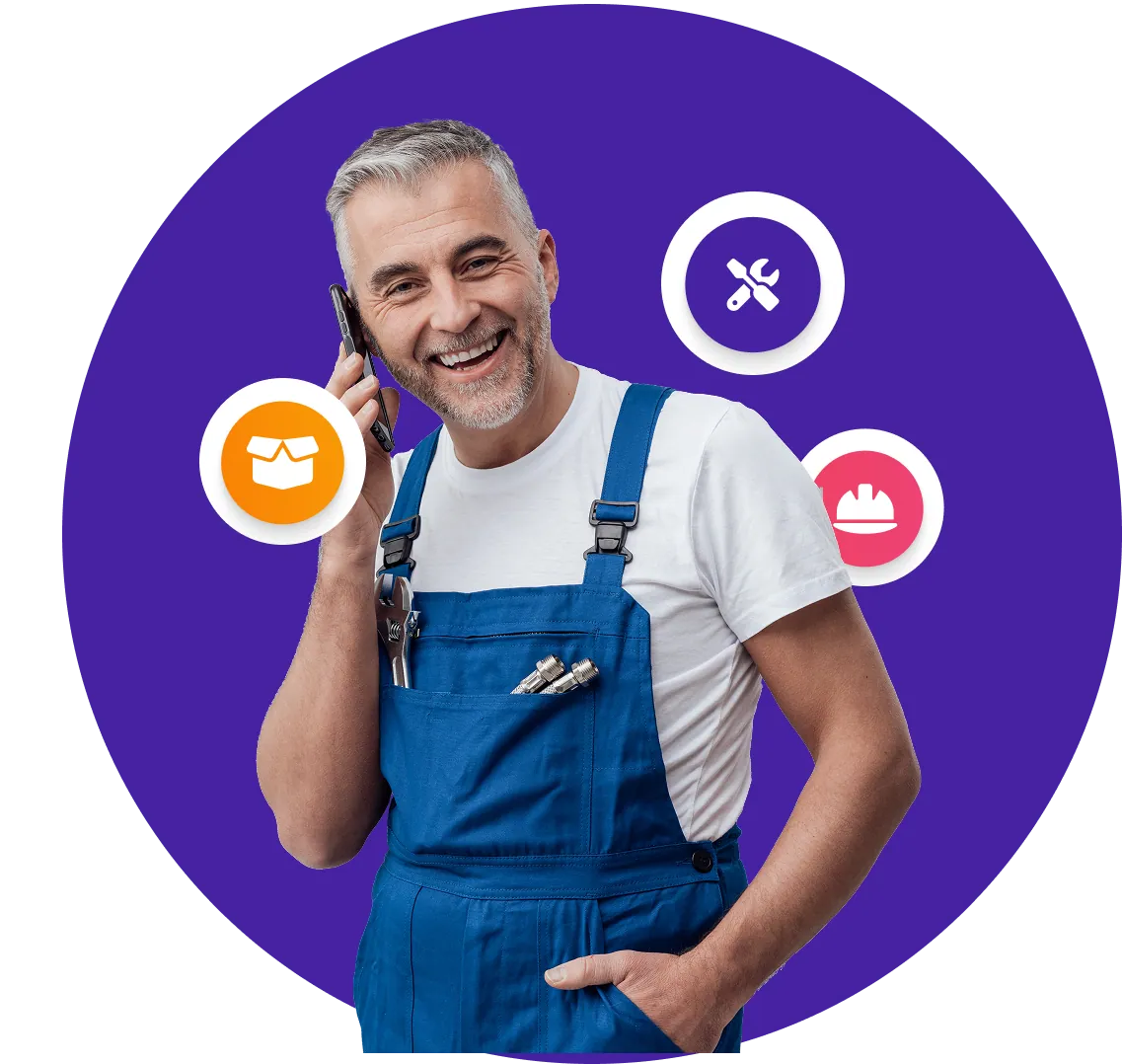 A tradie in overalls on the phone, smiling